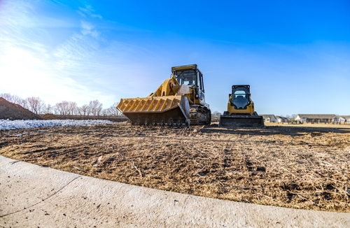 Track,Bulldozer,,Earth-moving,Equipment,At,Construction,Site,With,Bright,Blue