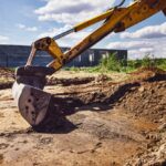 Excavator,Working,At,House,Construction,Site,-,Digging,Foundations,For