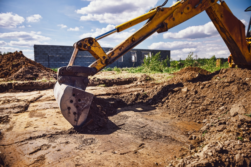 Excavator,Working,At,House,Construction,Site,-,Digging,Foundations,For