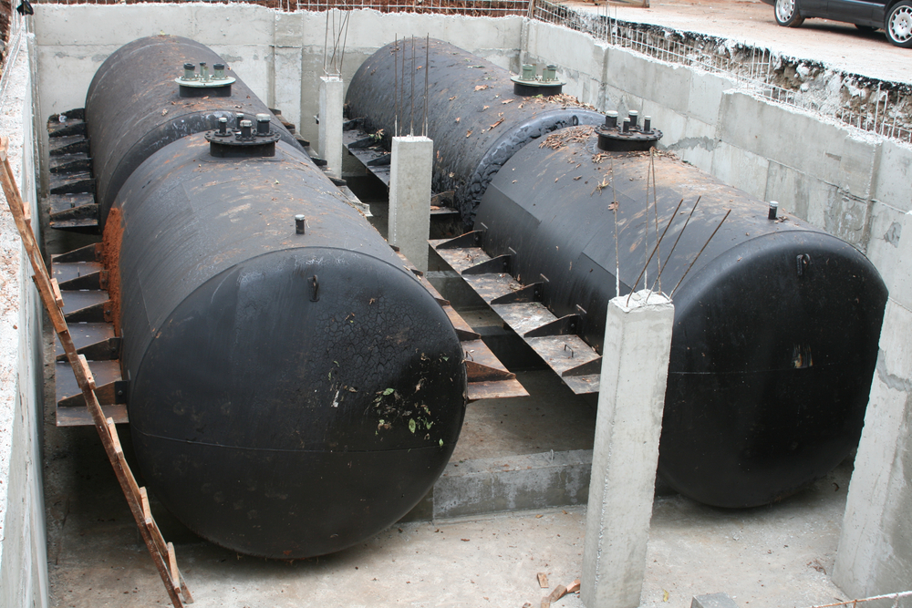 Four,Black,Large,Cylinder,Tanks,For,Underground,Gasoline,Storage,Installed